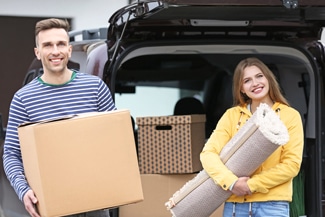 A Couple Carrying Boxes During Furniture Removals — Furniture removalists in Newcastle, NSW