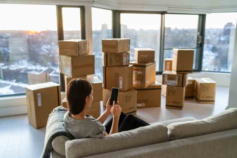 Girl Using Her Phone While Sitting In A Sofa — Furniture removalists in Newcastle, NSW